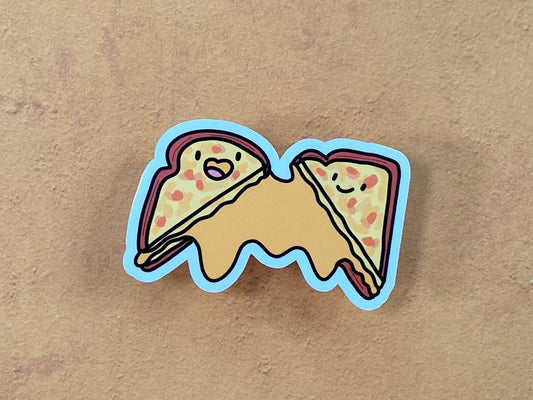 Cartoon grilled cheese with faces on a brown background