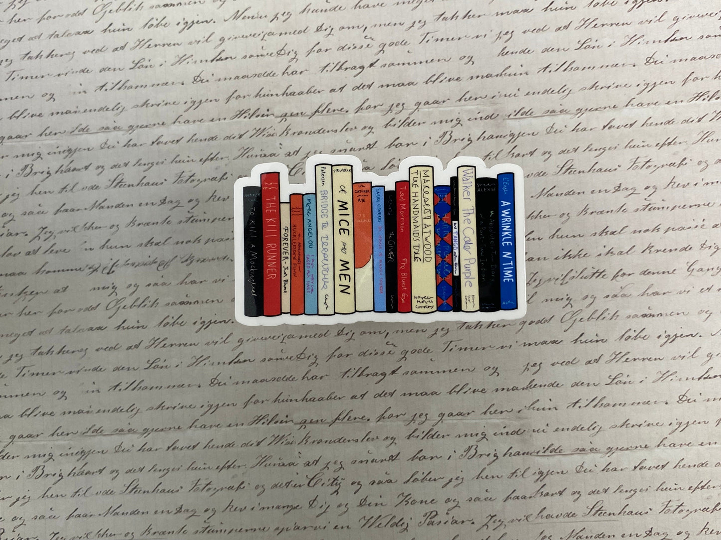 Decorative book-shaped sticker on a piece of handwritten text