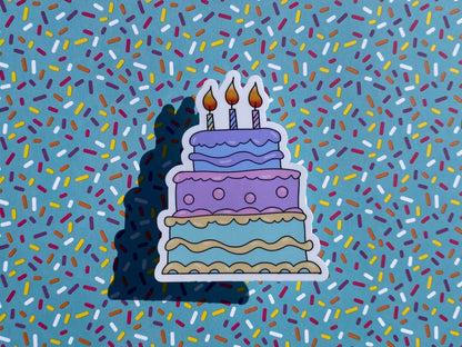 Sticker of a birthday cake with candles on a background of colorful sprinkles